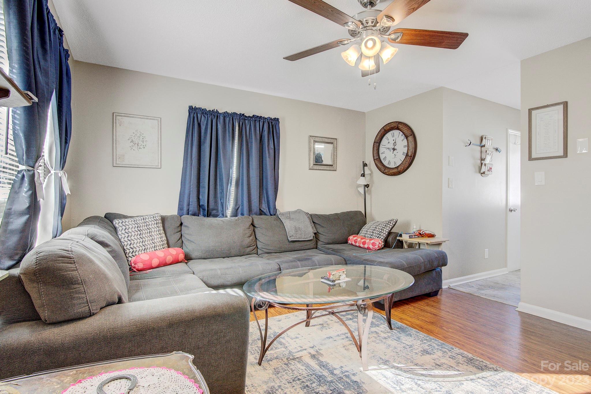 300 Newsome Road Salisbury, NC 28146 - Photo 10 of 27 a living room with furniture a clock on wall and a window