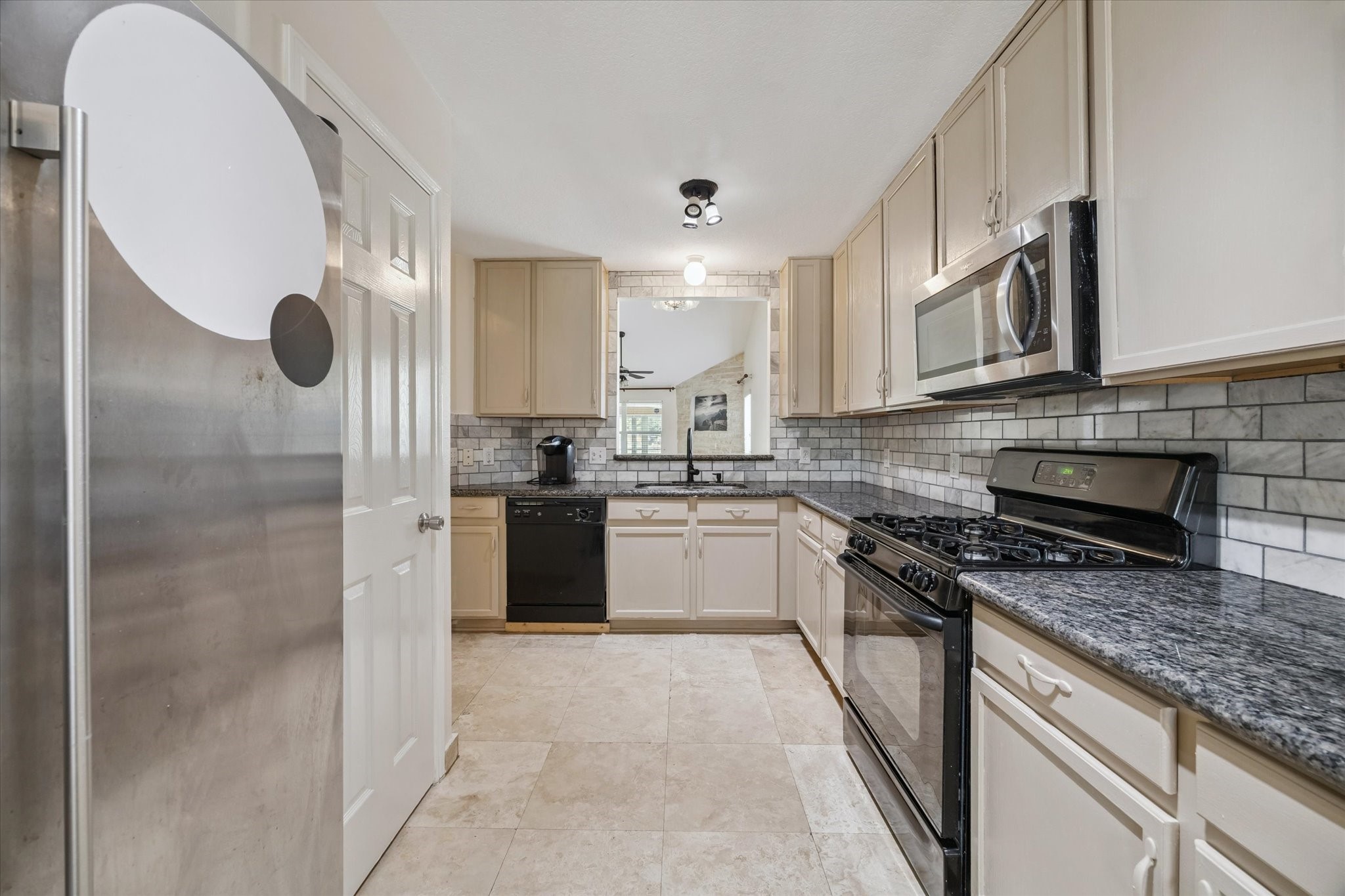 17610 Prospect Meadows Drive Houston, TX 77095 - Photo 12 of 33 a kitchen with stainless steel appliances granite countertop a stove a sink and a refrigerator