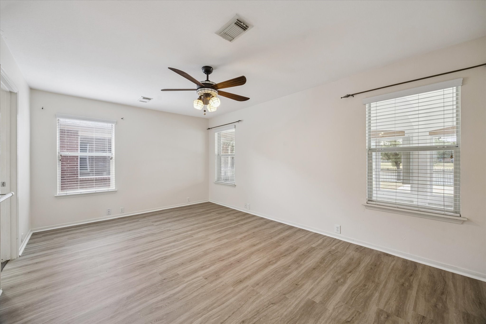 17610 Prospect Meadows Drive Houston, TX 77095 - Photo 13 of 33 a view of an empty room with a window and wooden floor