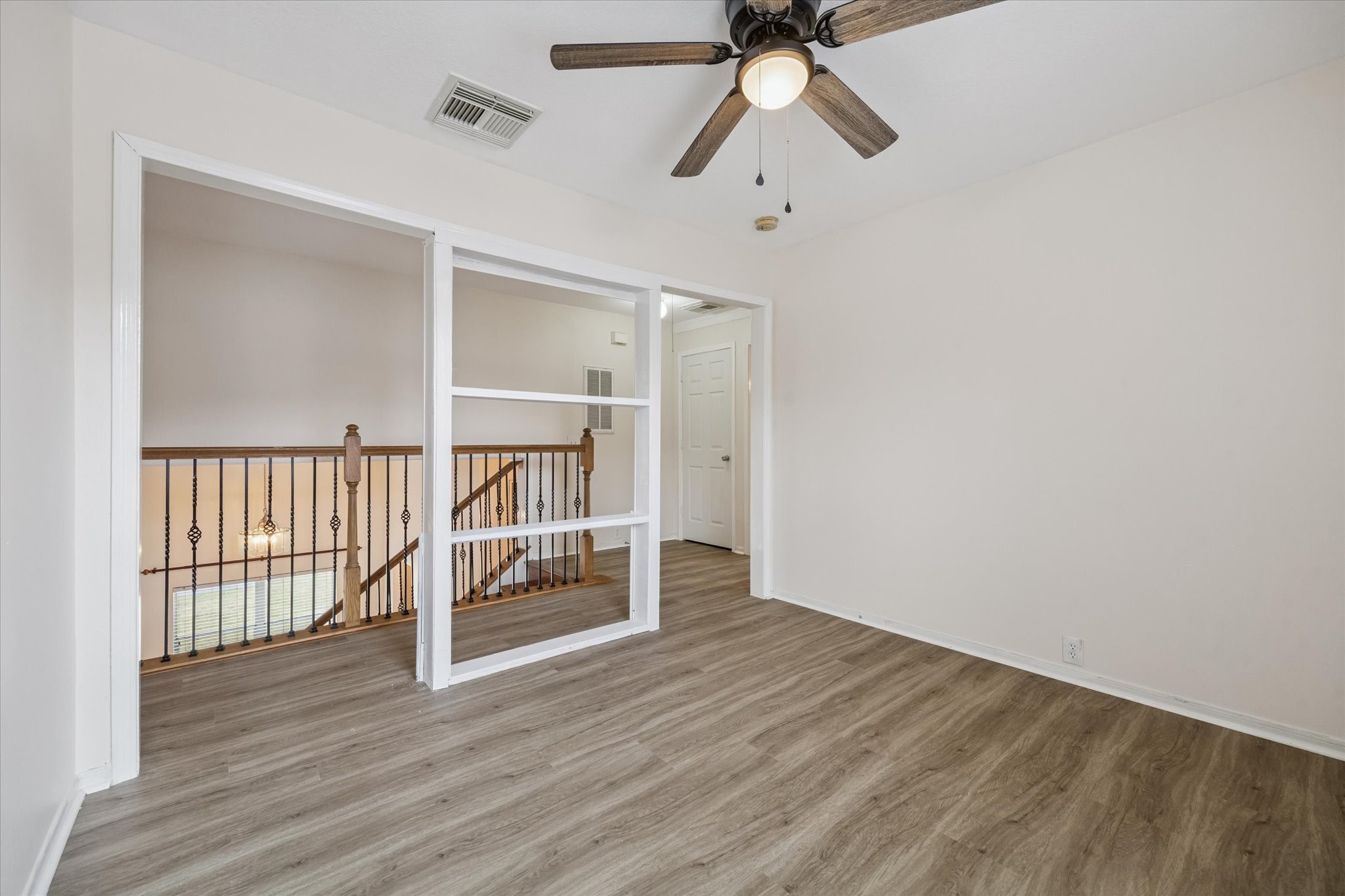 17610 Prospect Meadows Drive Houston, TX 77095 - Photo 20 of 33 an empty room with wooden floor fan and windows