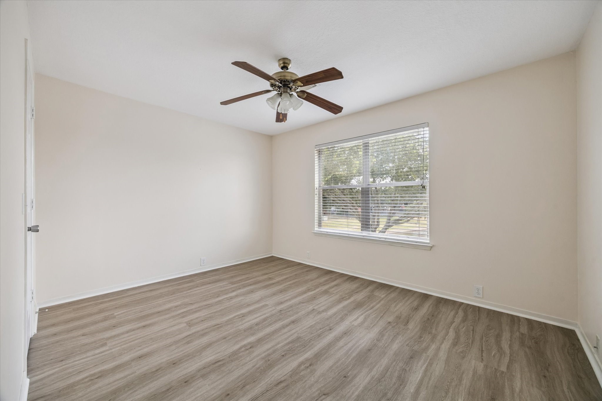 17610 Prospect Meadows Drive Houston, TX 77095 - Photo 22 of 33 a view of empty room with wooden floor and fan