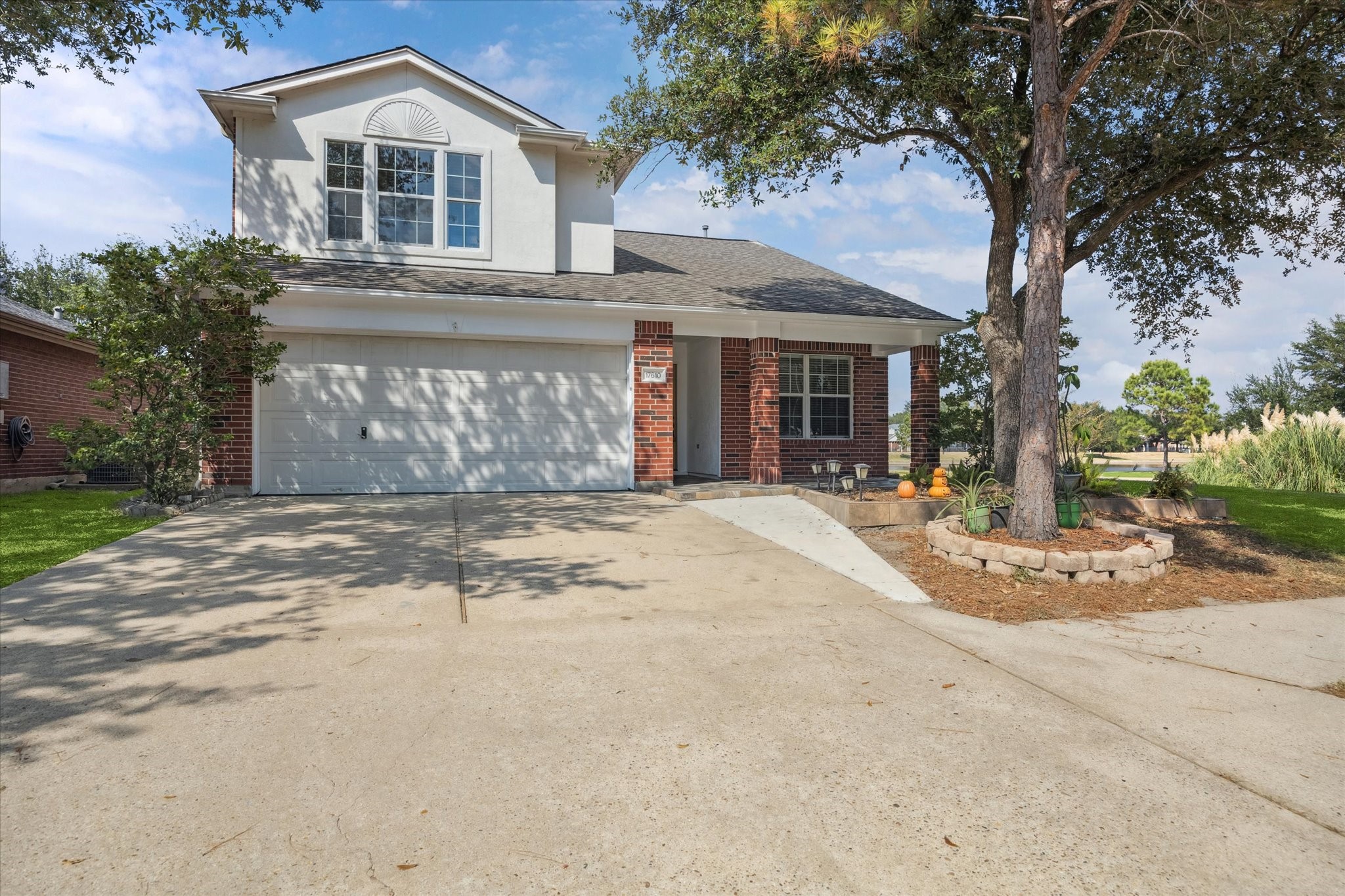 17610 Prospect Meadows Drive Houston, TX 77095 - Photo 3 of 33 a front view of a house with a yard and garage