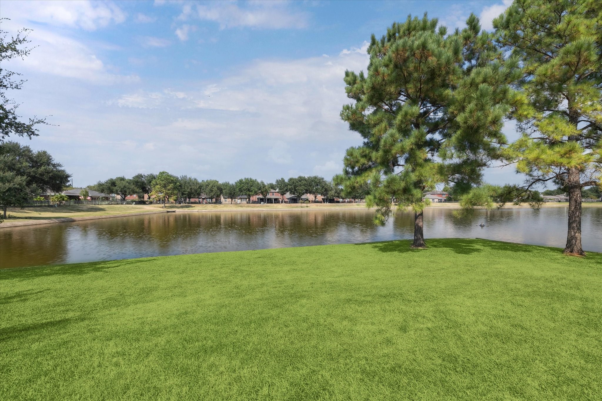 17610 Prospect Meadows Drive Houston, TX 77095 - Photo 33 of 33 a view of a lake with houses in the back