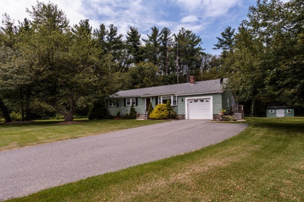 11 Garland Road Chelmsford, MA 01824 - Photo 19 of 19 a front view of a house with a garden and trees