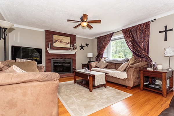 11 Garland Road Chelmsford, MA 01824 - Photo 6 of 19 a living room with furniture a fireplace and a flat screen tv