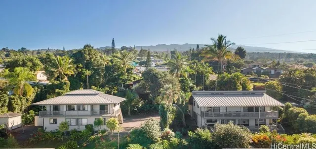 a front view of a building with a garden