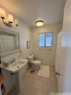 a bathroom with a sink mirror and toilet