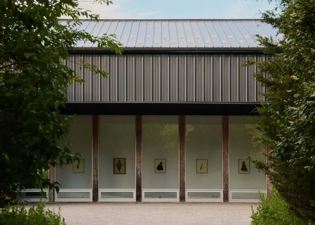 a wooden house with trees in front of it