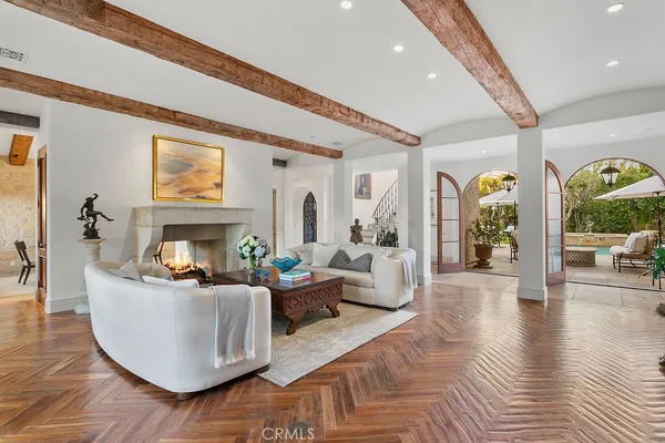 a living room with fireplace furniture and a large window