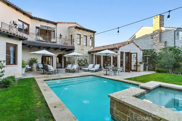 a front view of a house with swimming pool having outdoor seating