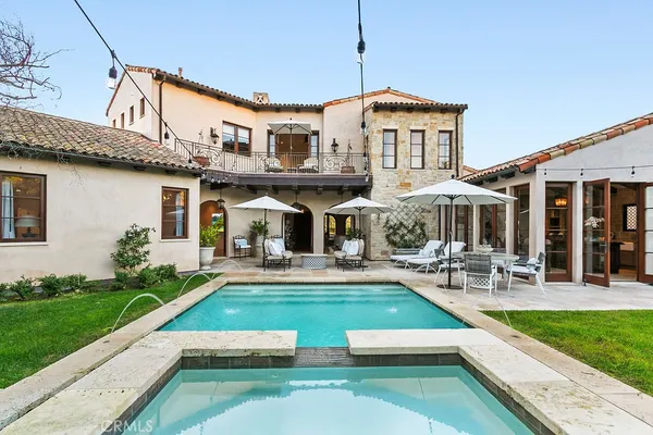 a view of a house with a yard patio and swimming pool