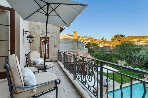 a living room with furniture large windows and a fireplace