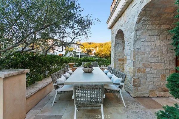 a view of a patio with table and chairs and potted plants