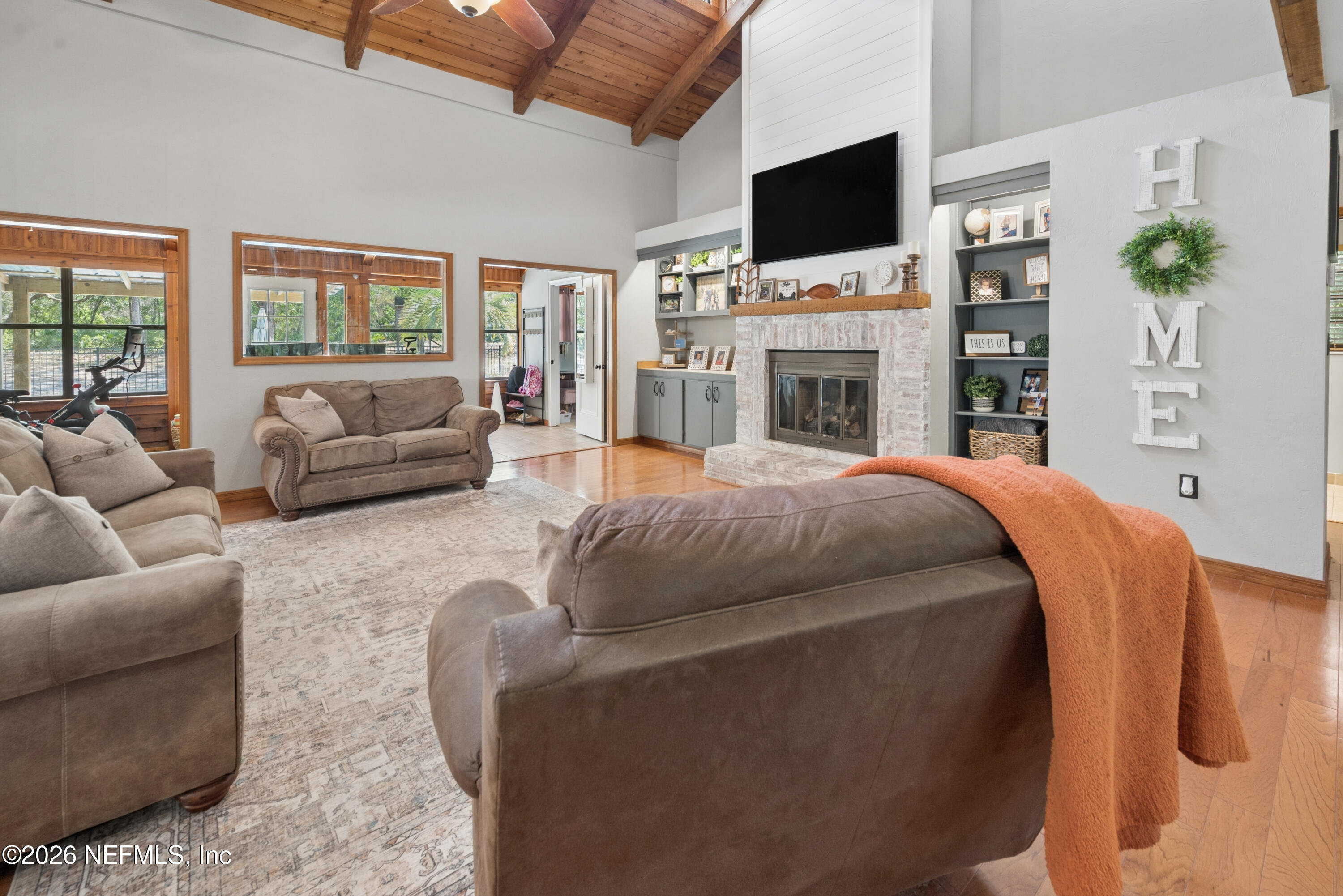 6519 Neale Road Melrose, FL 32666 - Photo 13 of 48 a living room with furniture a flat screen tv and a fireplace