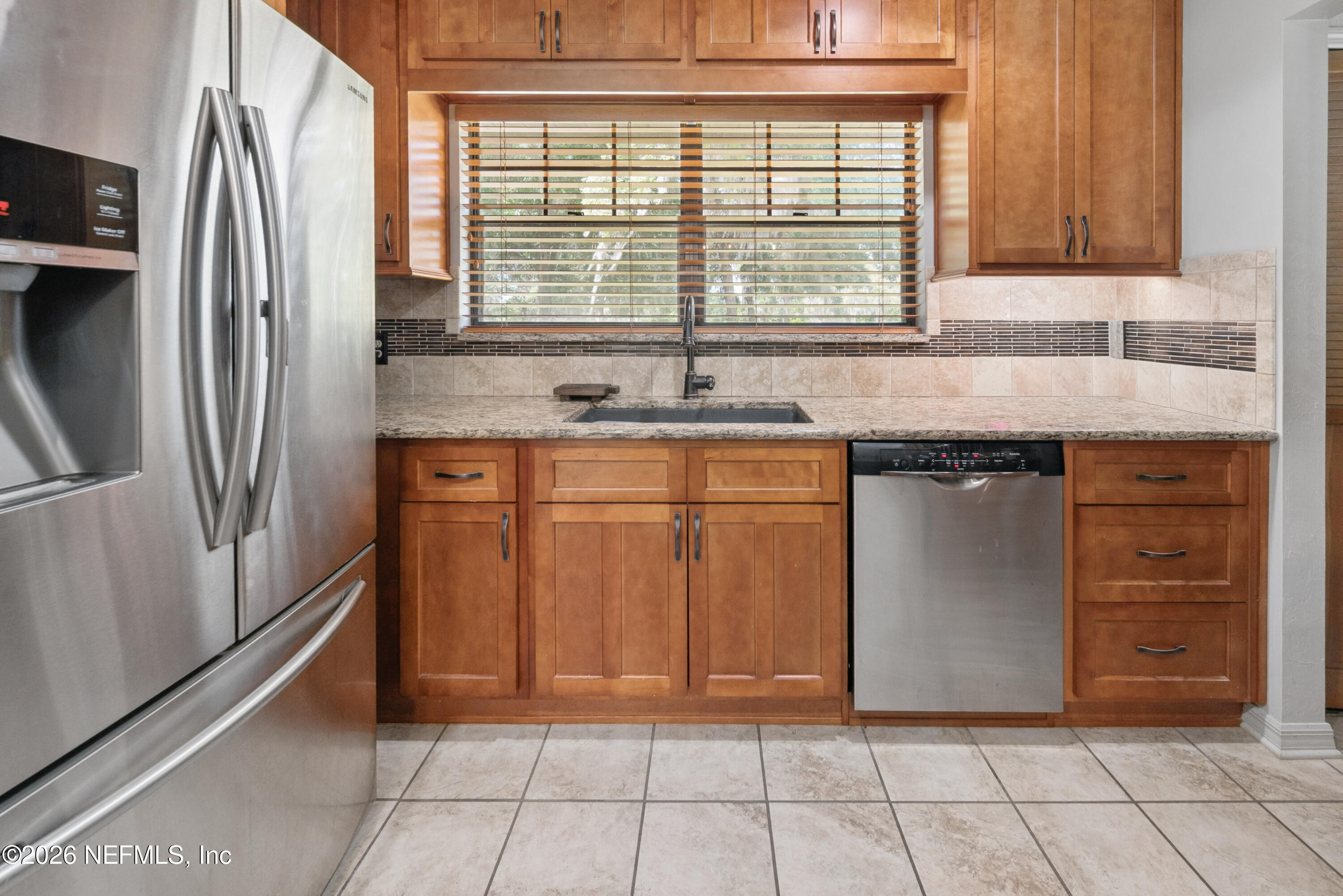 6519 Neale Road Melrose, FL 32666 - Photo 18 of 48 a kitchen with stainless steel appliances granite countertop a refrigerator and a sink
