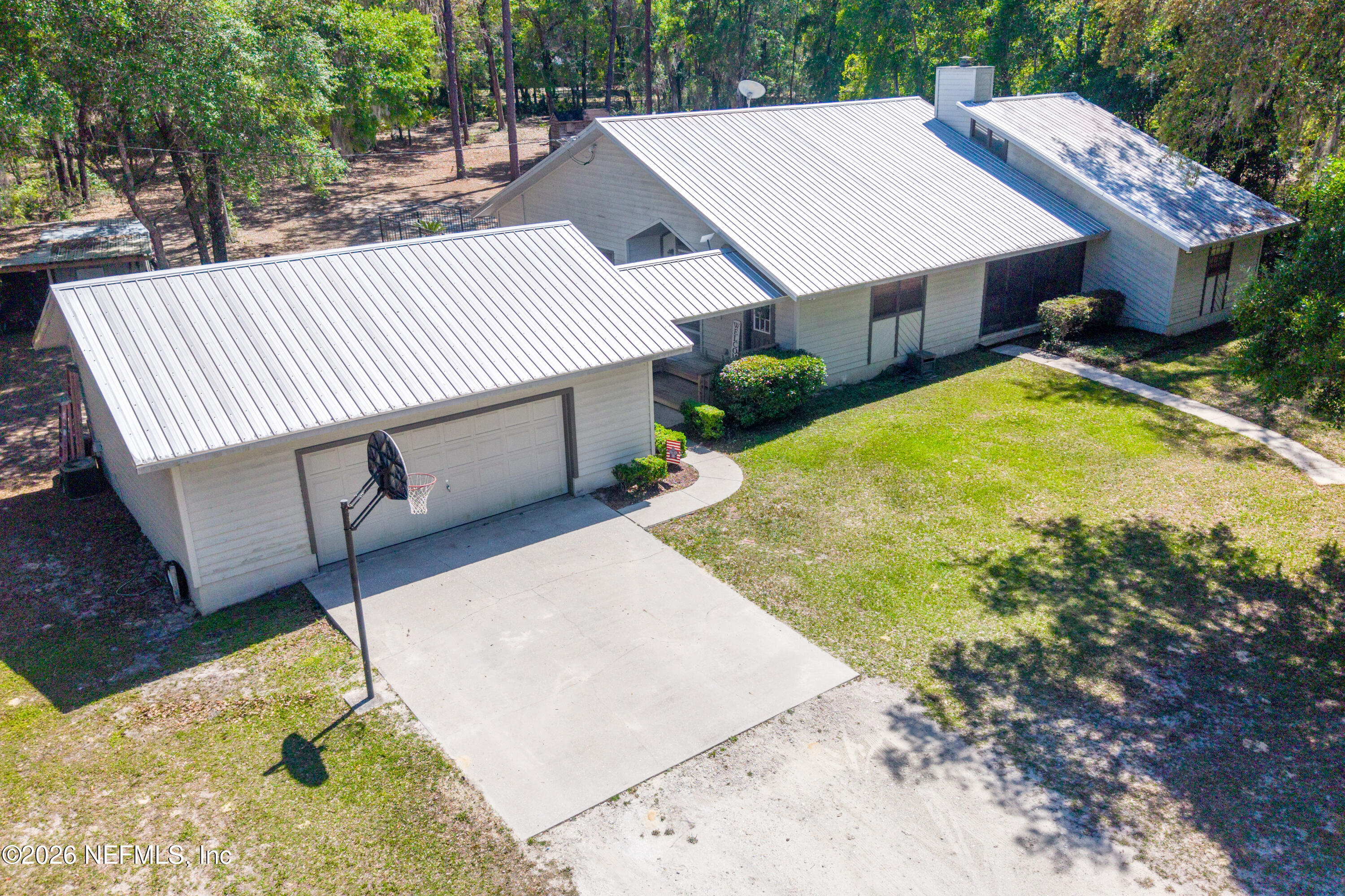 6519 Neale Road Melrose, FL 32666 - Photo 2 of 48 a view of a patio with table and chairs with wooden fence