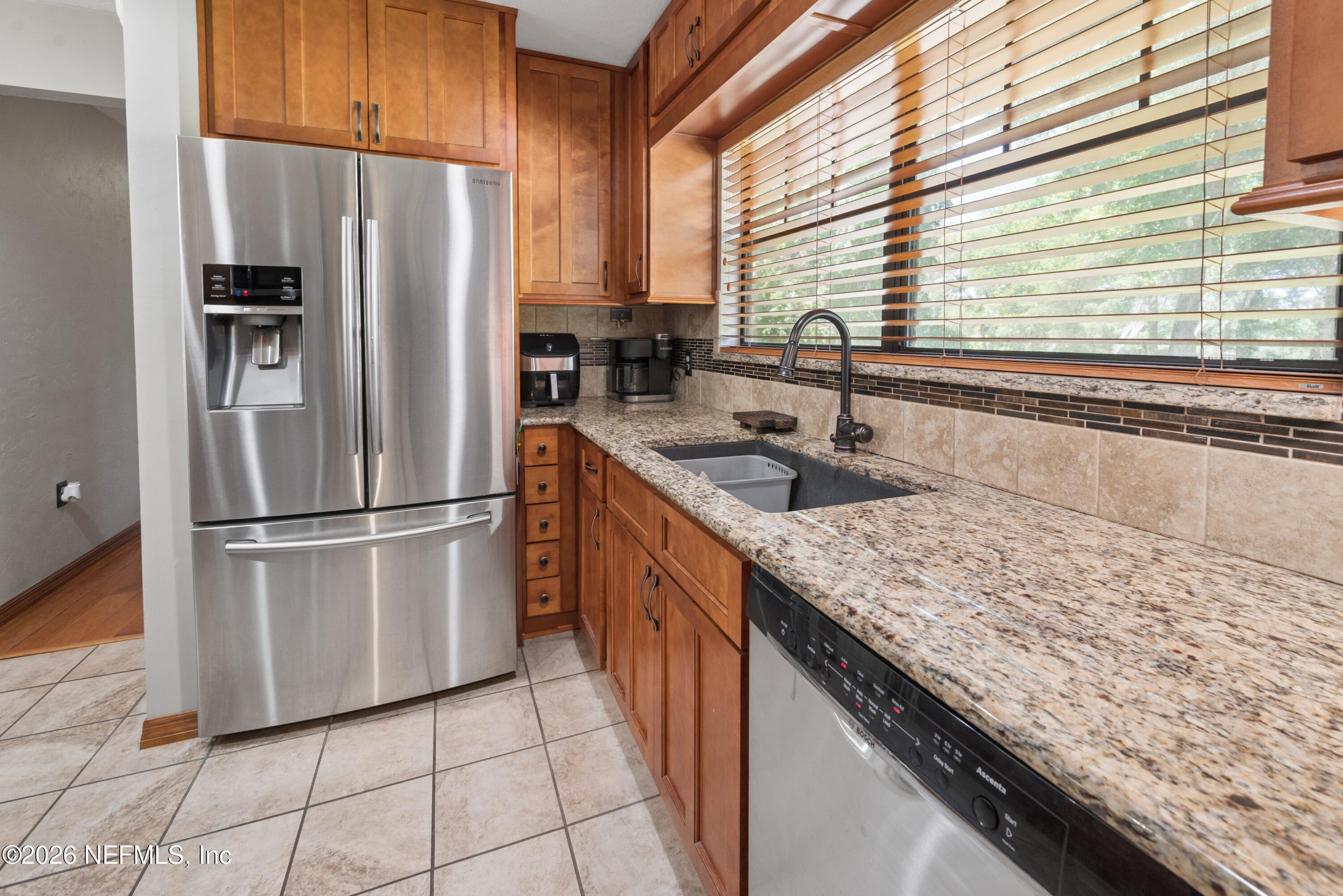 6519 Neale Road Melrose, FL 32666 - Photo 21 of 48 a kitchen with stainless steel appliances granite countertop a sink a refrigerator and a counter space