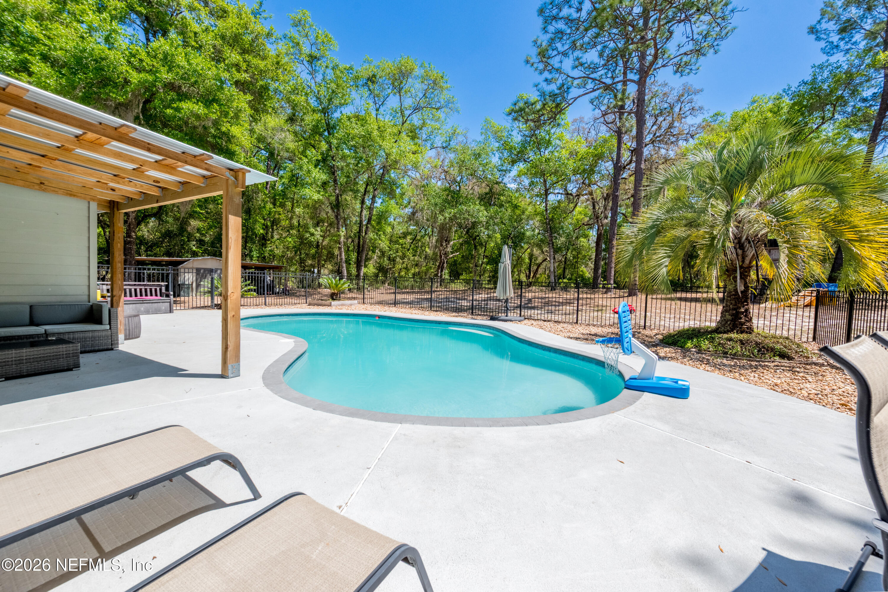 6519 Neale Road Melrose, FL 32666 - Photo 3 of 48 a view of a swimming pool with an outdoor seating