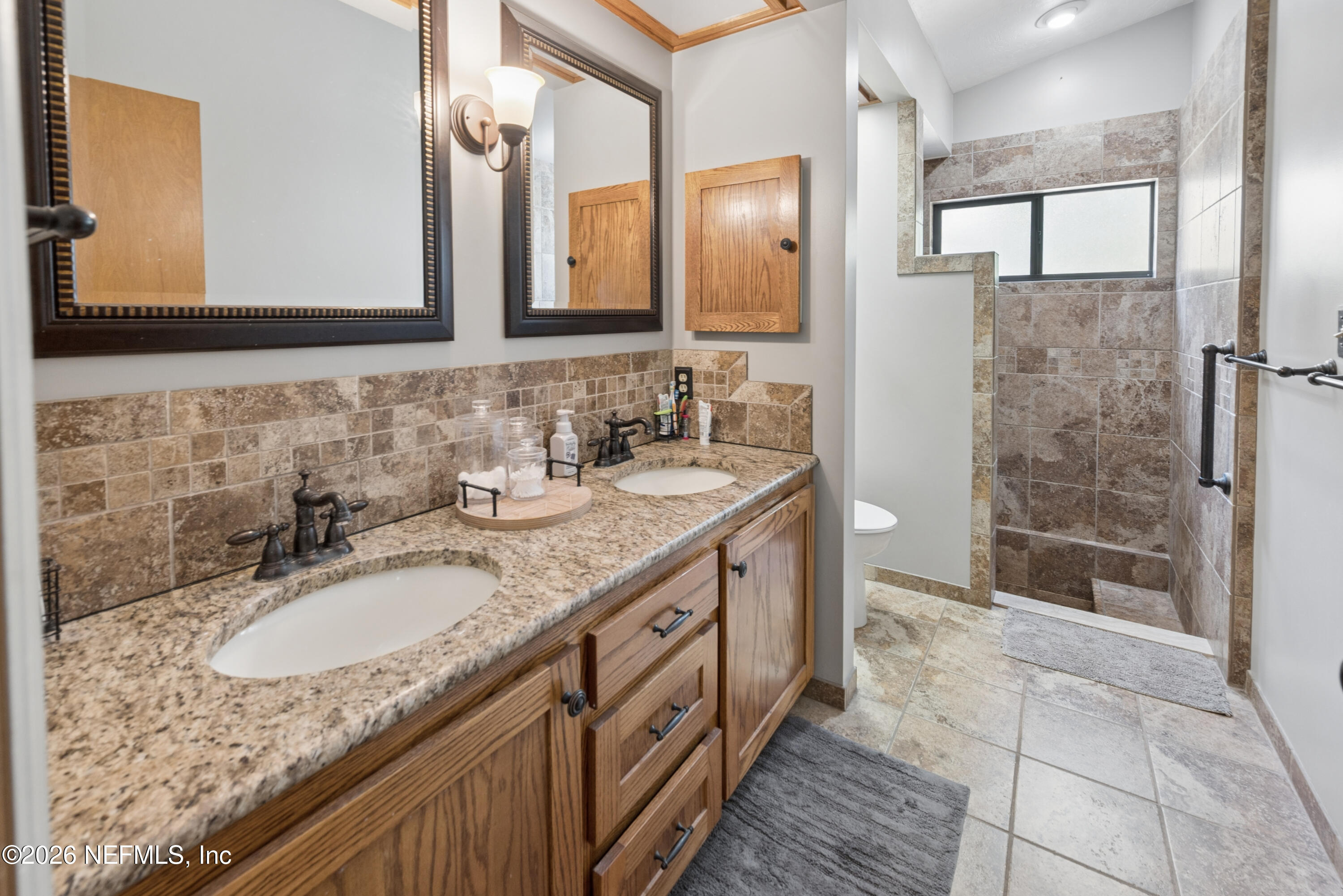 6519 Neale Road Melrose, FL 32666 - Photo 32 of 48 a bathroom with a granite countertop double vanity sink and a mirror