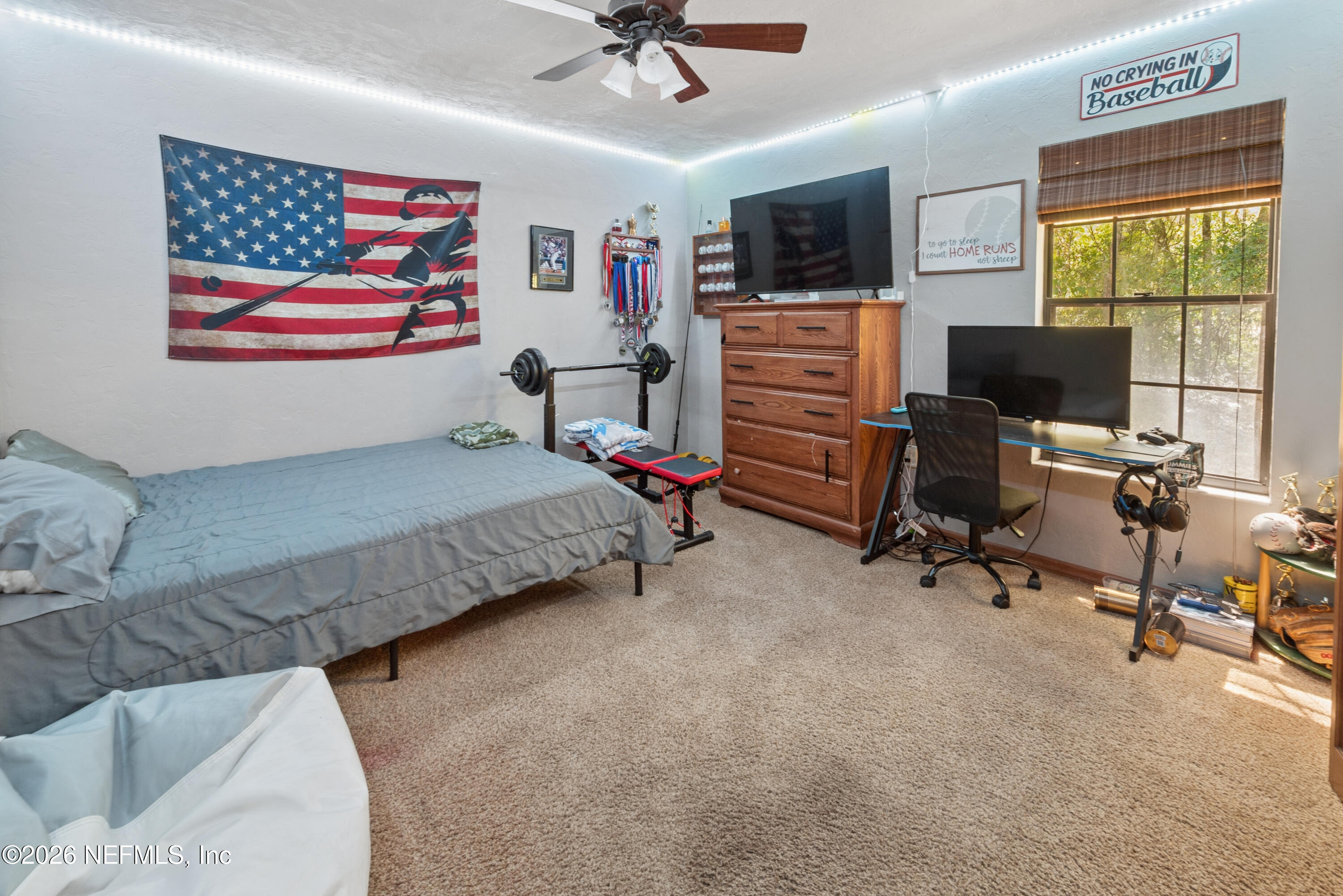 6519 Neale Road Melrose, FL 32666 - Photo 34 of 48 a bedroom with a bed and furniture