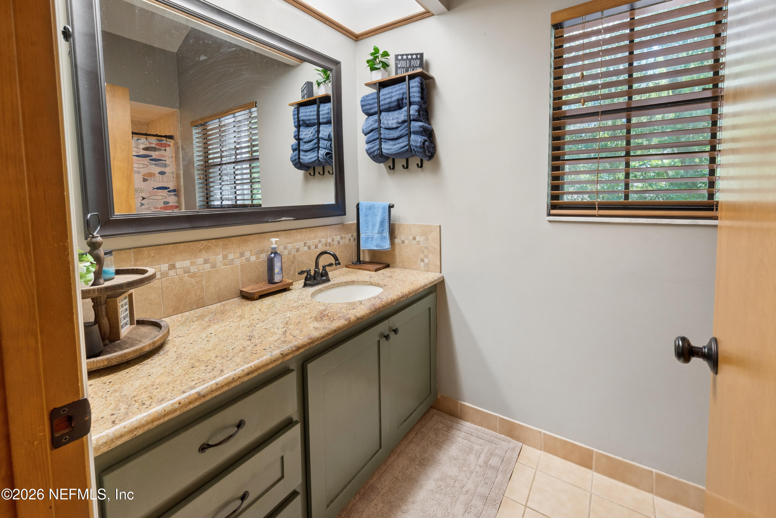 6519 Neale Road Melrose, FL 32666 - Photo 35 of 48 a bathroom with a granite countertop sink and a mirror