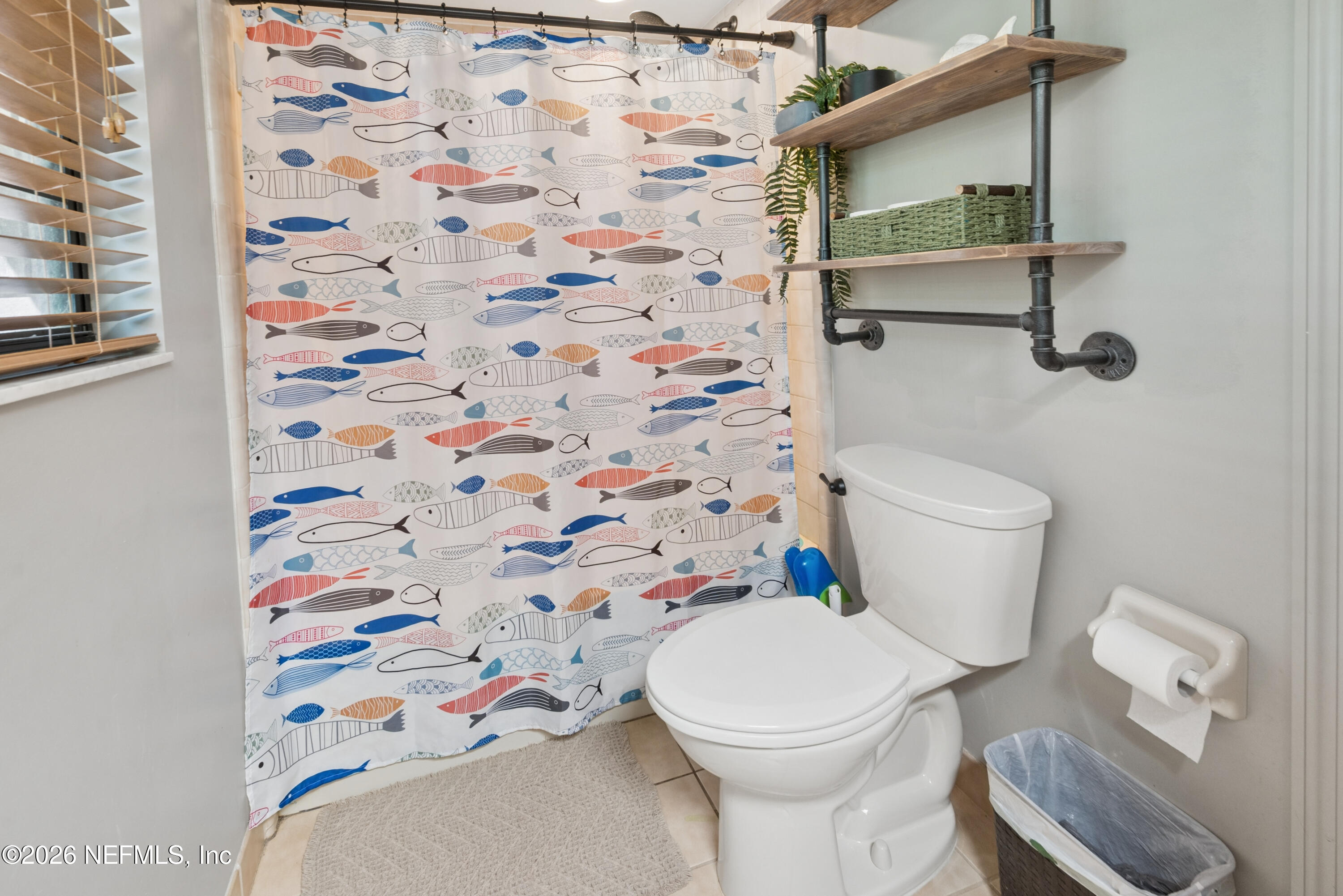 6519 Neale Road Melrose, FL 32666 - Photo 36 of 48 a white toilet sitting next to a shower curtain