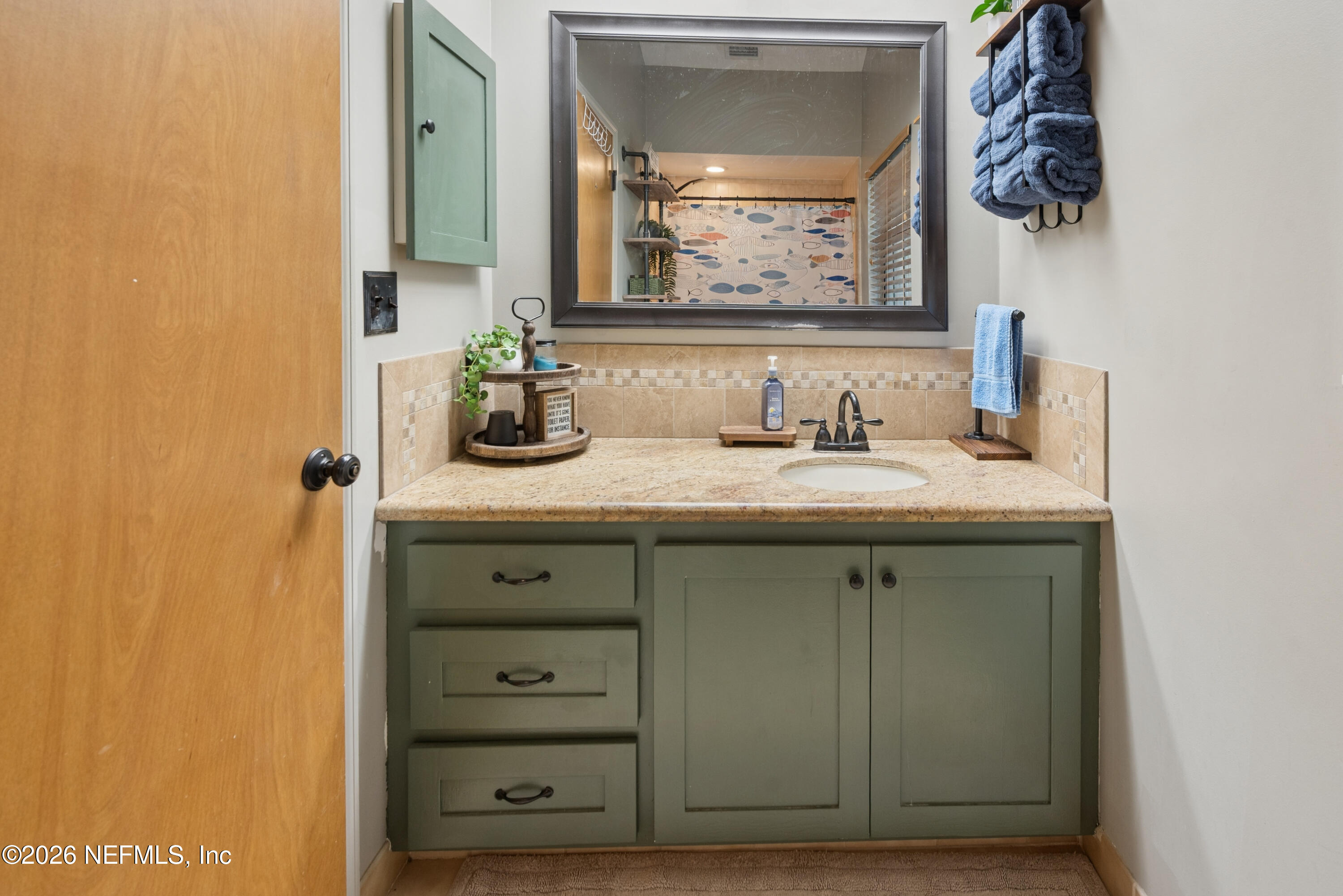 6519 Neale Road Melrose, FL 32666 - Photo 37 of 48 a bathroom with a sink and a mirror
