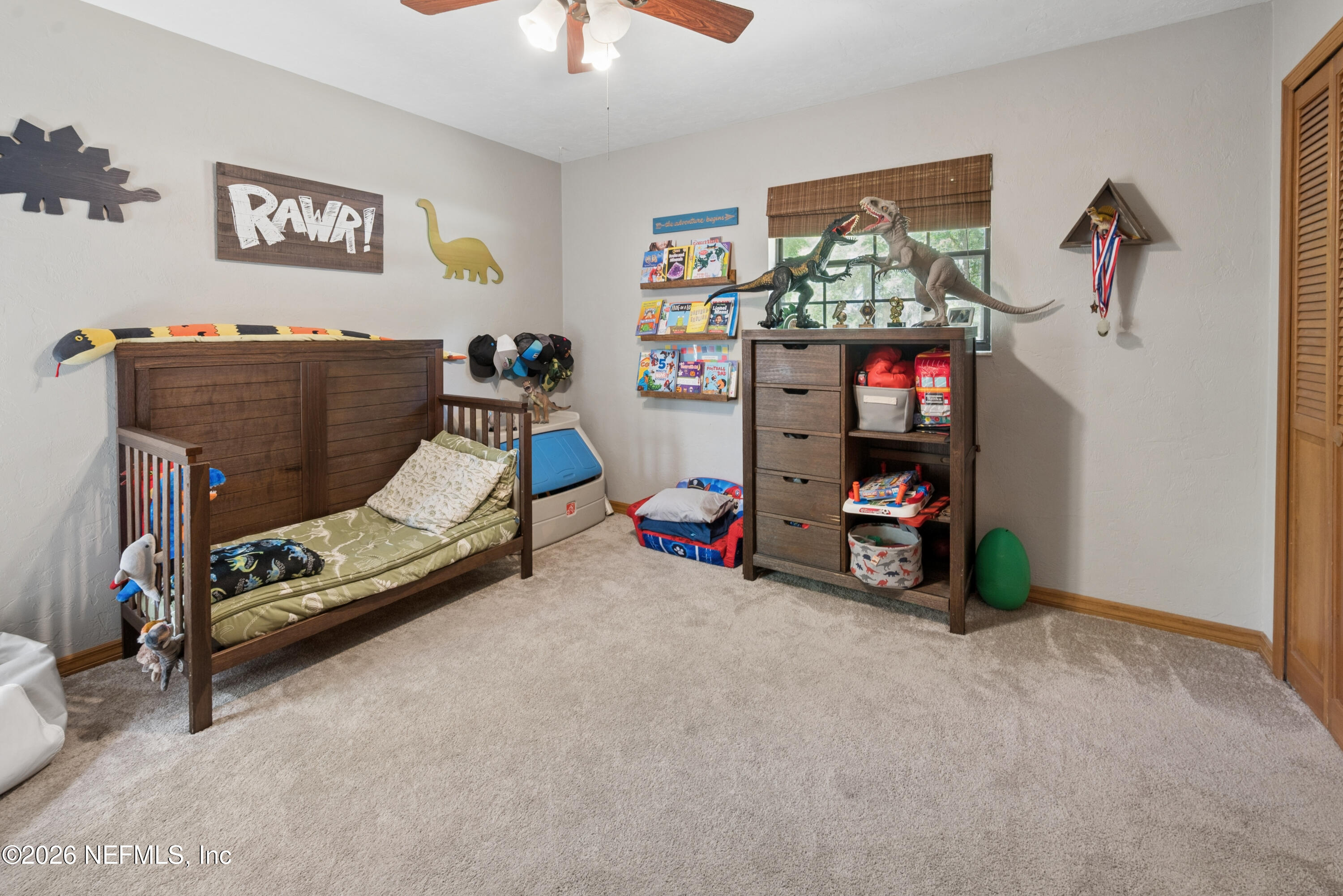 6519 Neale Road Melrose, FL 32666 - Photo 40 of 48 a bedroom with furniture and a flat screen tv