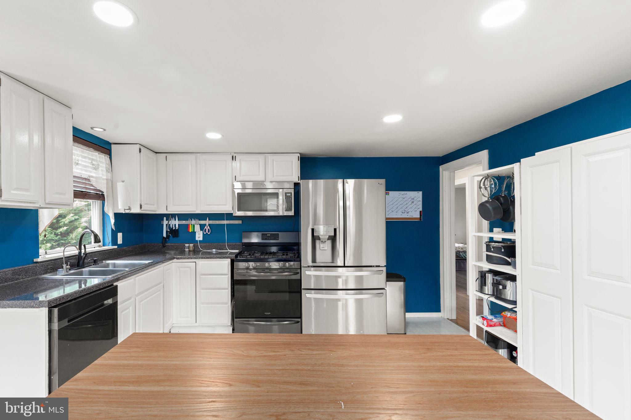 105 Mechanics Valley Road North East, MD 21901 - Photo 9 of 34 Modern kitchen with vibrant blue accents.