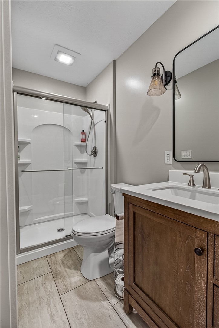 8700 Quaker Trace Road Camden, OH 45311 - Photo 17 of 34 This bright bathroom features a spacious shower, a modern vanity, and sleek tile flooring.