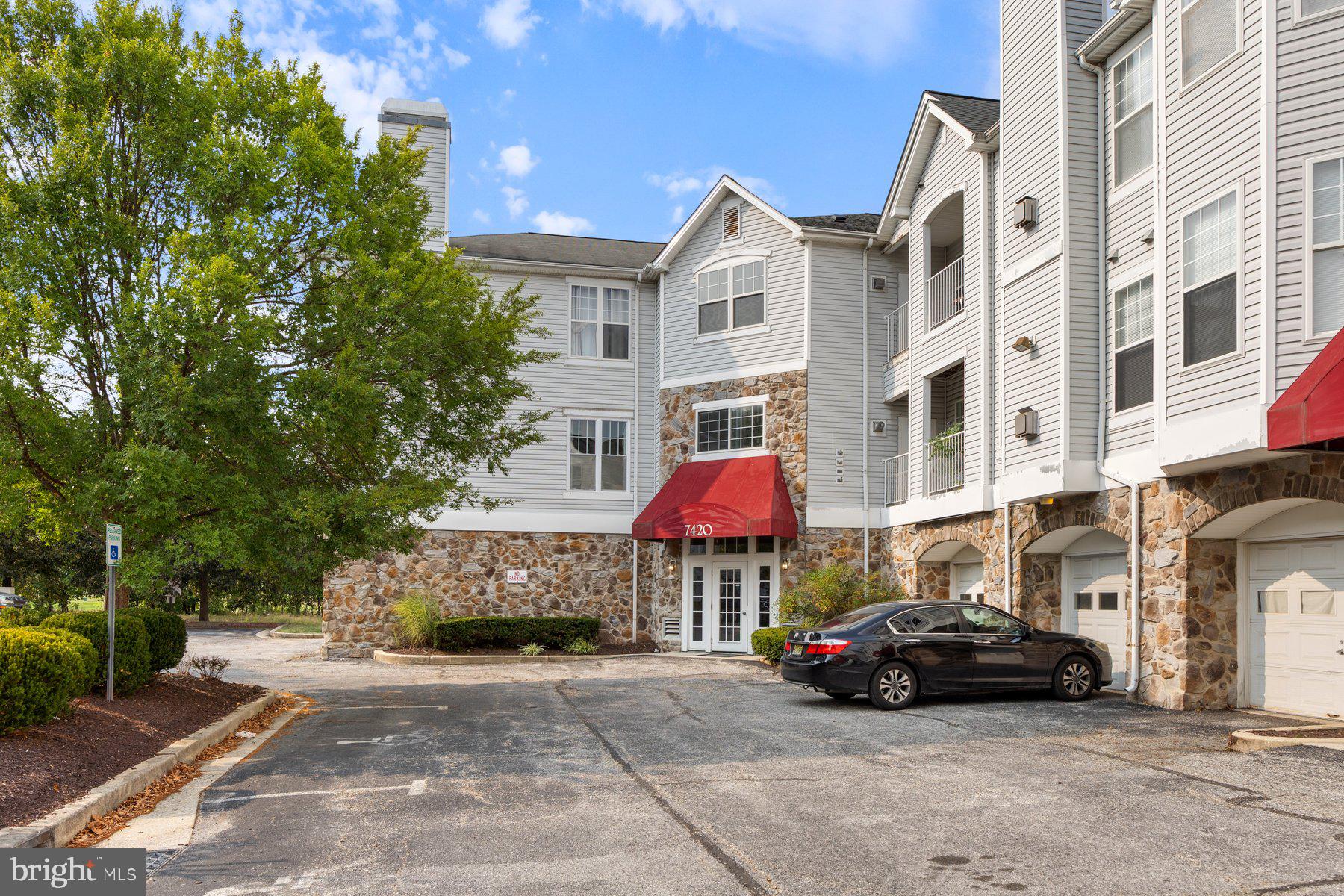 a view of a cars park in front of a brick building