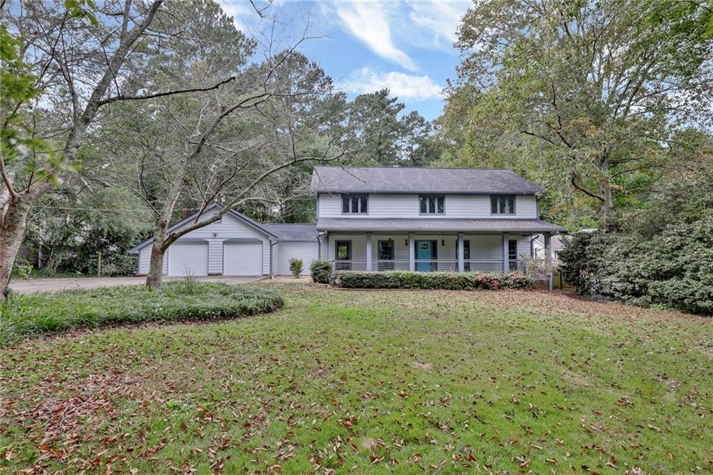 1863 Bill Murdock Road Marietta, GA 30062 - Photo 1 of 1 a view of a big house with a big yard and large trees