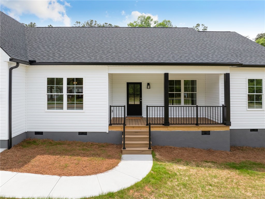 1735 Maw Bridge Road Central, SC 29630 - Photo 4 of 38 This charming home features a welcoming porch, a dark front door, and crisp white siding.