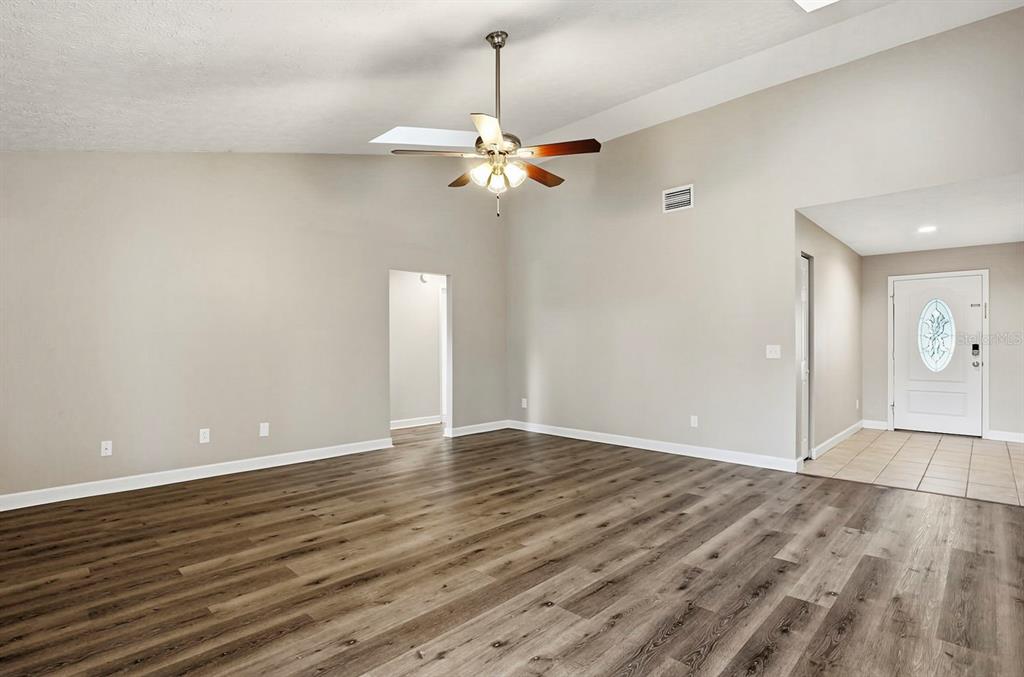 15009 Naples Place Tampa, FL 33624 - Photo 13 of 42 a view of an empty room with window and a chandelier fan
