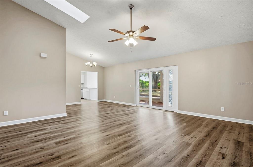 15009 Naples Place Tampa, FL 33624 - Photo 16 of 42 a view of an empty room with wooden floor and a window
