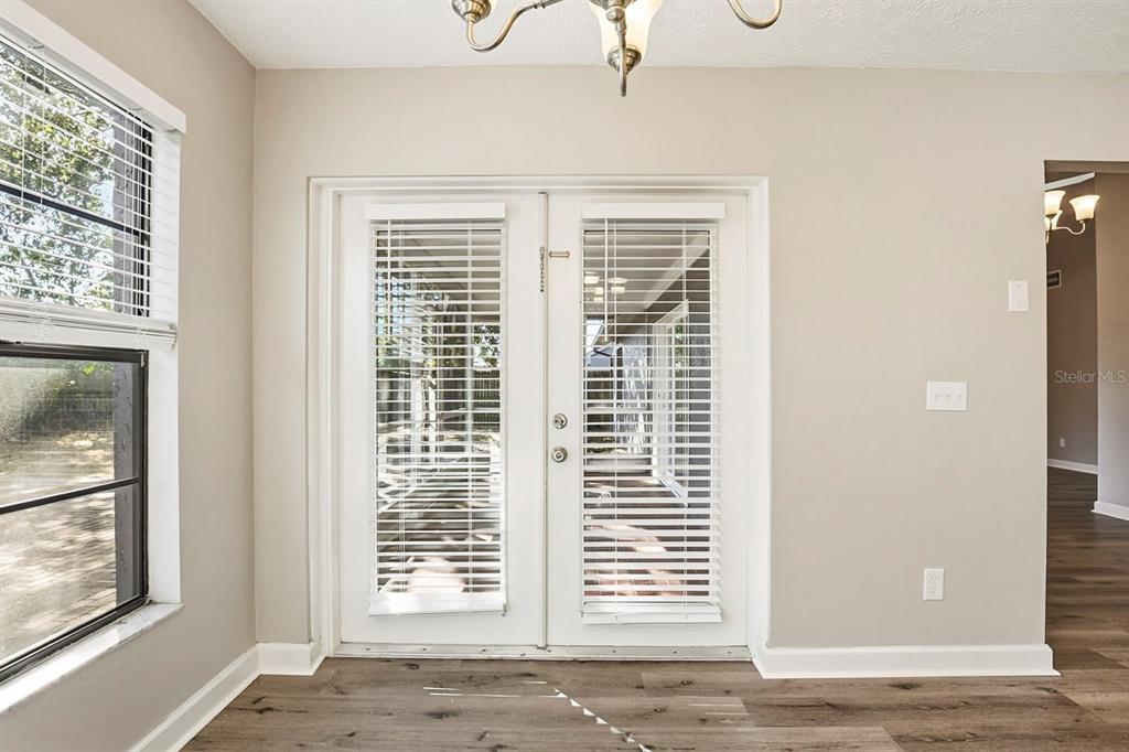 15009 Naples Place Tampa, FL 33624 - Photo 22 of 42 a view of an empty room with a window and wooden floor