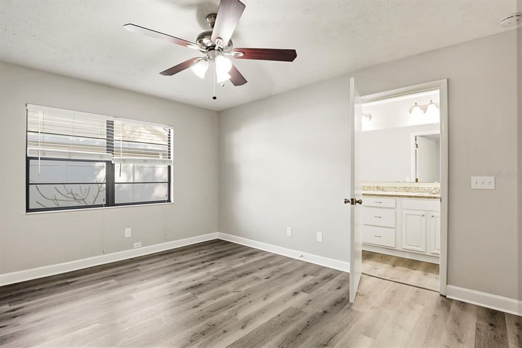 15009 Naples Place Tampa, FL 33624 - Photo 23 of 42 wooden floor in an empty room with a window
