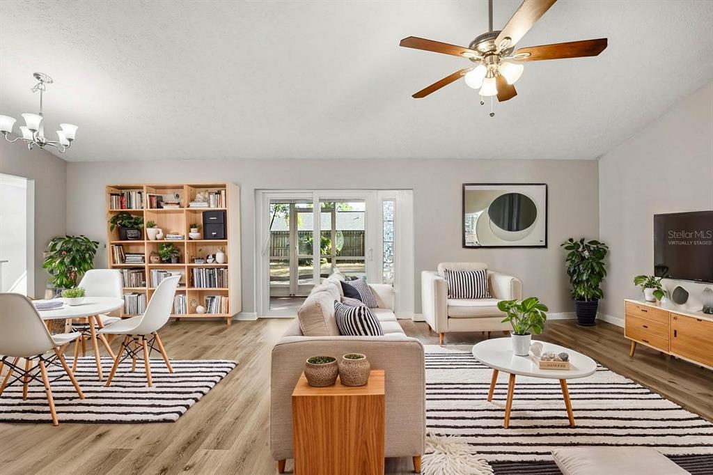 15009 Naples Place Tampa, FL 33624 - Photo 3 of 42 a living room with furniture a ceiling fan and a flat screen tv