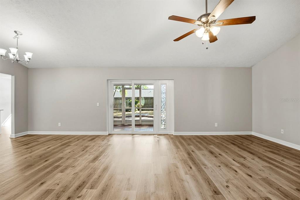 15009 Naples Place Tampa, FL 33624 - Photo 4 of 42 wooden floor in an empty room with a window
