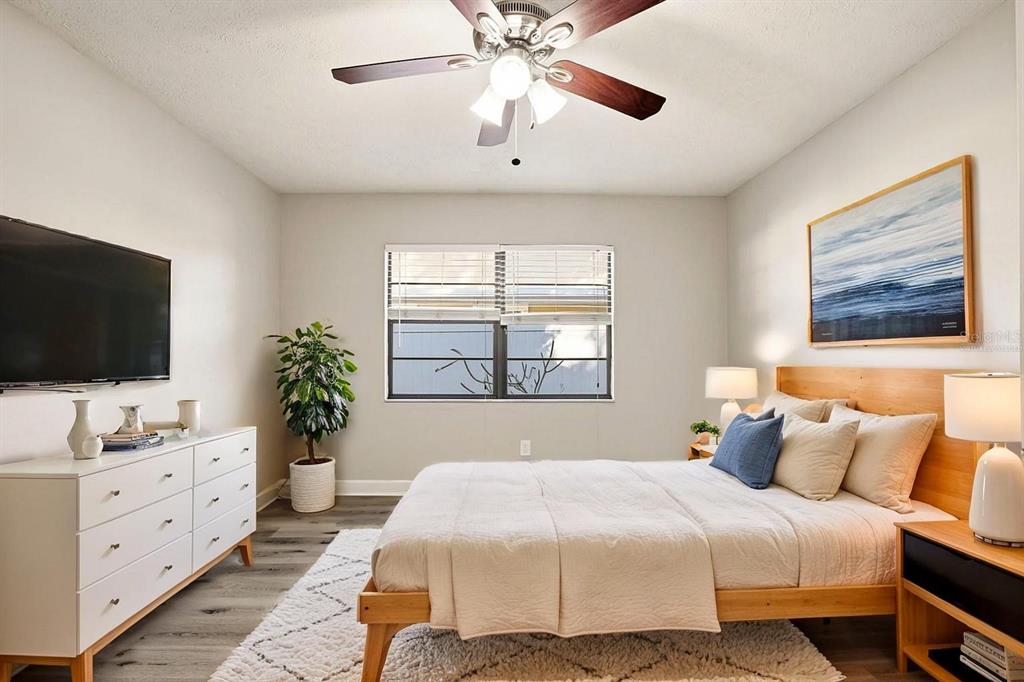 15009 Naples Place Tampa, FL 33624 - Photo 7 of 42 a bedroom with a bed and a flat screen tv