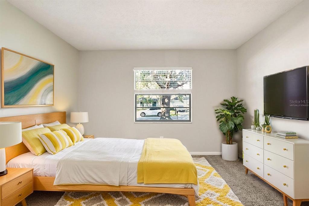 15009 Naples Place Tampa, FL 33624 - Photo 9 of 42 a bedroom with a bed and a flat screen tv