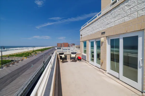 a view of a balcony with two chairs and a table