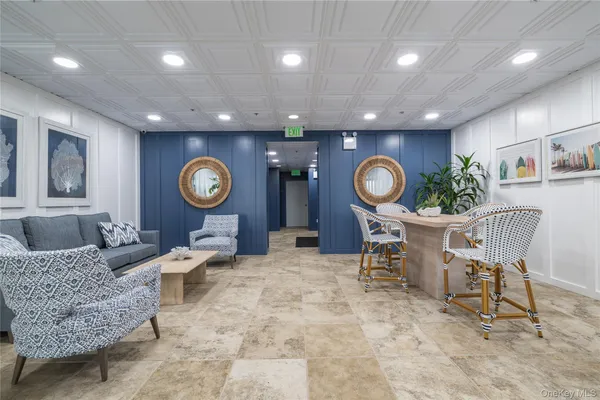 a living room with furniture a rug and a large mirror