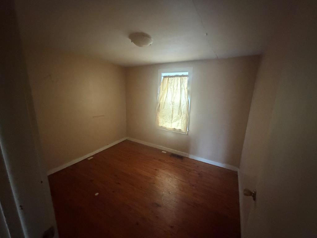 316 Lake Drive Morganton, GA 30560 - Photo 26 of 41 an empty room with wooden floor and windows