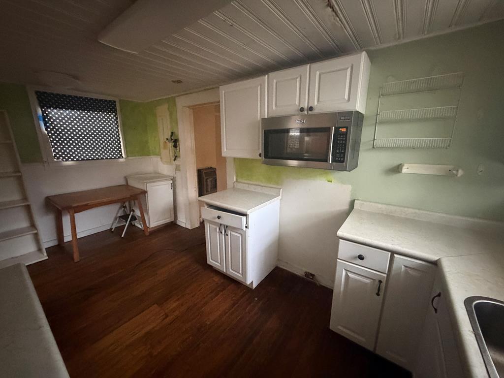 316 Lake Drive Morganton, GA 30560 - Photo 37 of 41 a kitchen with cabinets and wooden floor