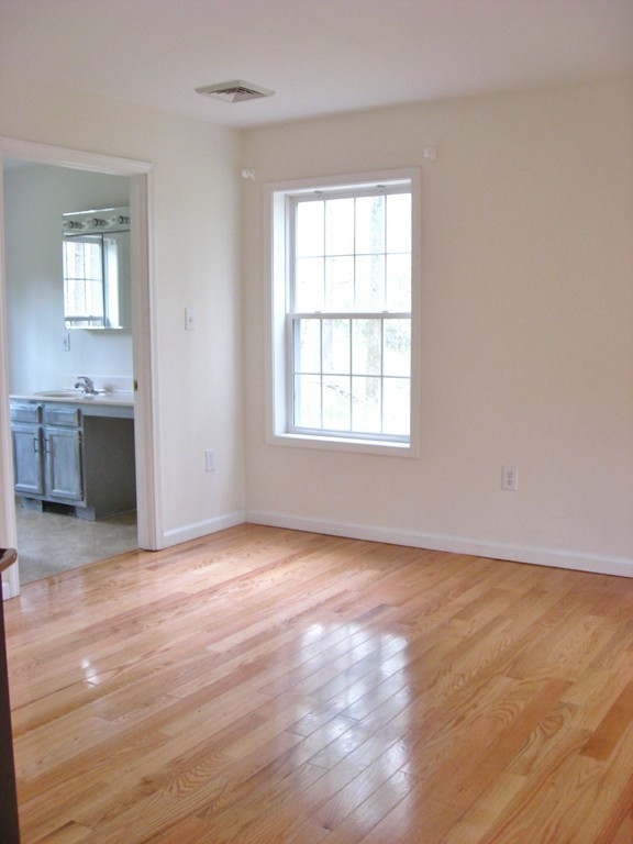 81 Depot Road Leverett, MA 01054 - Photo 13 of 21 an empty room with wooden floor cabinet and windows