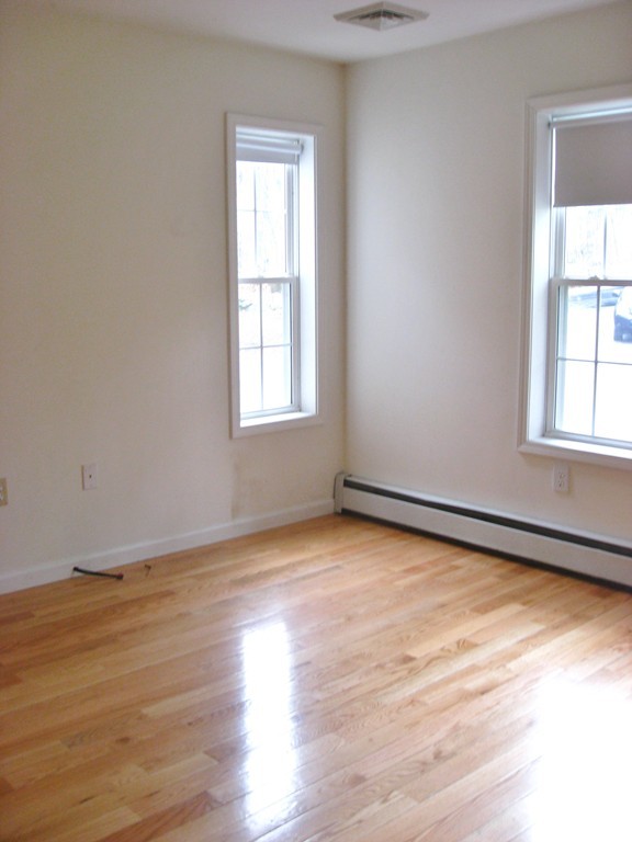 81 Depot Road Leverett, MA 01054 - Photo 17 of 21 an empty room with wooden floor and windows