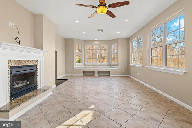 a view of an empty room with a fireplace and a window