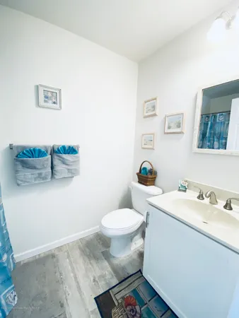 a bathroom with a sink toilet and a mirror