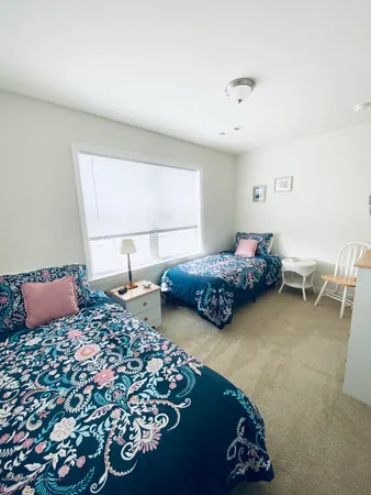 a bedroom with two beds and a couch